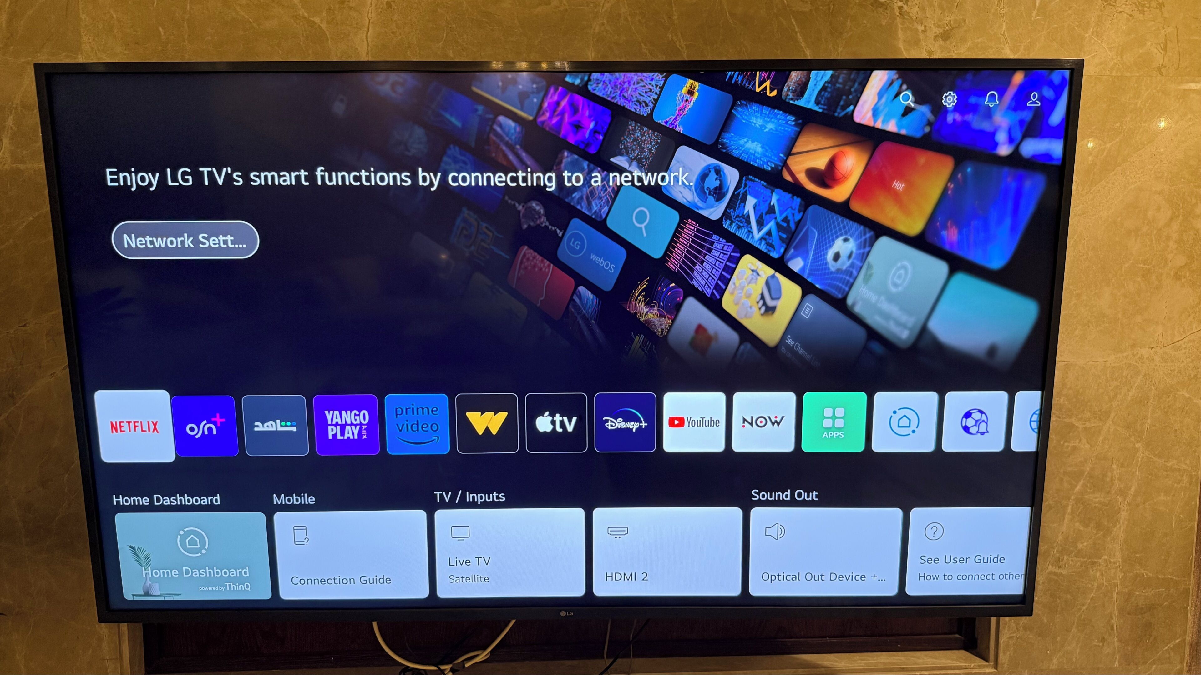A television screen displaying a smart TV interface with various streaming services and connectivity options.