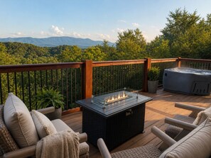 A deck with a fire pit, outdoor seating, and a hot tub. - Douglas Lake Access + Smoky Mtn Views + Hot Tub + Fire Pit (Dandridge)