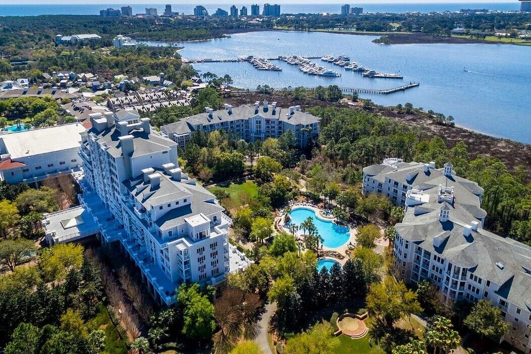 A resort with multiple buildings, a marina, and a swimming pool.
