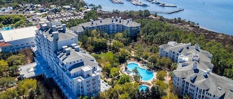 A resort with multiple buildings, a marina, and a swimming pool.