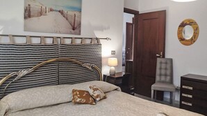 A hotel room with a bed, a chair, a desk, and a painting on the wall. - Casa della Mamma by Interhome (Sanremo)