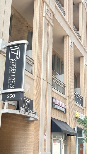 A multi-story building with a sign for 'Street Lofts at Atlantic Station' and a '17th Street Lofts' sign. - Spacious 3/3 bedrooms- Walk to Eats, Shops and Entertainment (Atlanta)