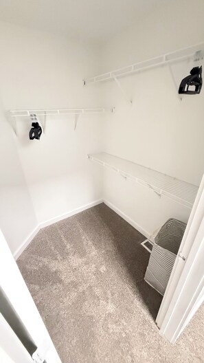 A room with a carpeted floor, white walls, and a built-in shelving unit. - Spacious 3/3 bedrooms- Walk to Eats, Shops and Entertainment (Atlanta)