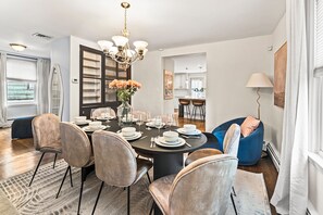 A dining area with a round table set for six, surrounded by six chairs. - LUX 4BR Somerville, Steps to Green Line, Free Parking, Game Room+Poker Table (Somerville)