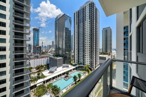 A high-rise building with a rooftop pool and a view of other high-rise buildings. - Crosby Miami WTC 1BR/1BA Cool Residence #2210 (Miami)