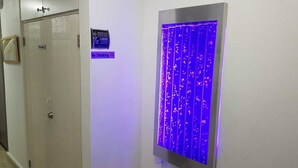 En privat dør med skilt, der angiver røgfri zone, og et blå oplyst panel.