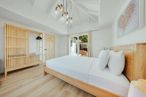 A bedroom with a wooden bed, a wooden wardrobe, a hanging light fixture, and a view of the outdoors. - 2 Mins from Beach • 3BR Villa Mango - Beach House (Noord)