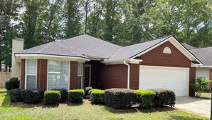 A two-story house with a garage, a covered front porch, and a well-maintained lawn. - Beautiful 3-bedroom home near Southeast hospital and downtown Dothan (Dothan)