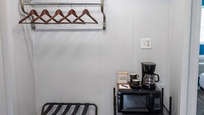 A kitchenette with a microwave, coffee maker, and hanging clothes rack. - The Naturalist`s Cabin at The Cedar (Sandusky)
