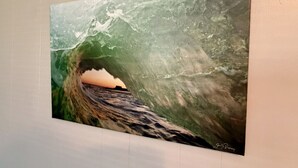 A framed artwork of a wave tunnel with a sunset view. - The Naturalist`s Cabin at The Cedar (Sandusky)