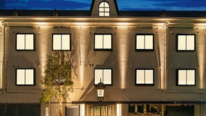 A building with multiple windows, a covered entrance, and a parking area. - HOTEL KEI - Adults Only  (Himeji)