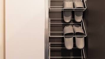 A built-in shoe rack with multiple shelves holding shoes.
