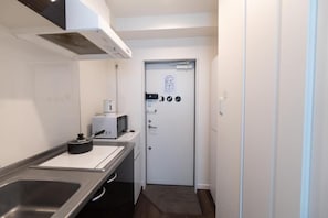 A small kitchenette with a microwave, toaster, and sink. - 5963 Hotel Higashi Ikebukuro (Tokyo)