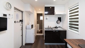 A compact kitchen with a microwave, refrigerator, and sink. - 5963 Hotel Higashi Ikebukuro (Tokyo)
