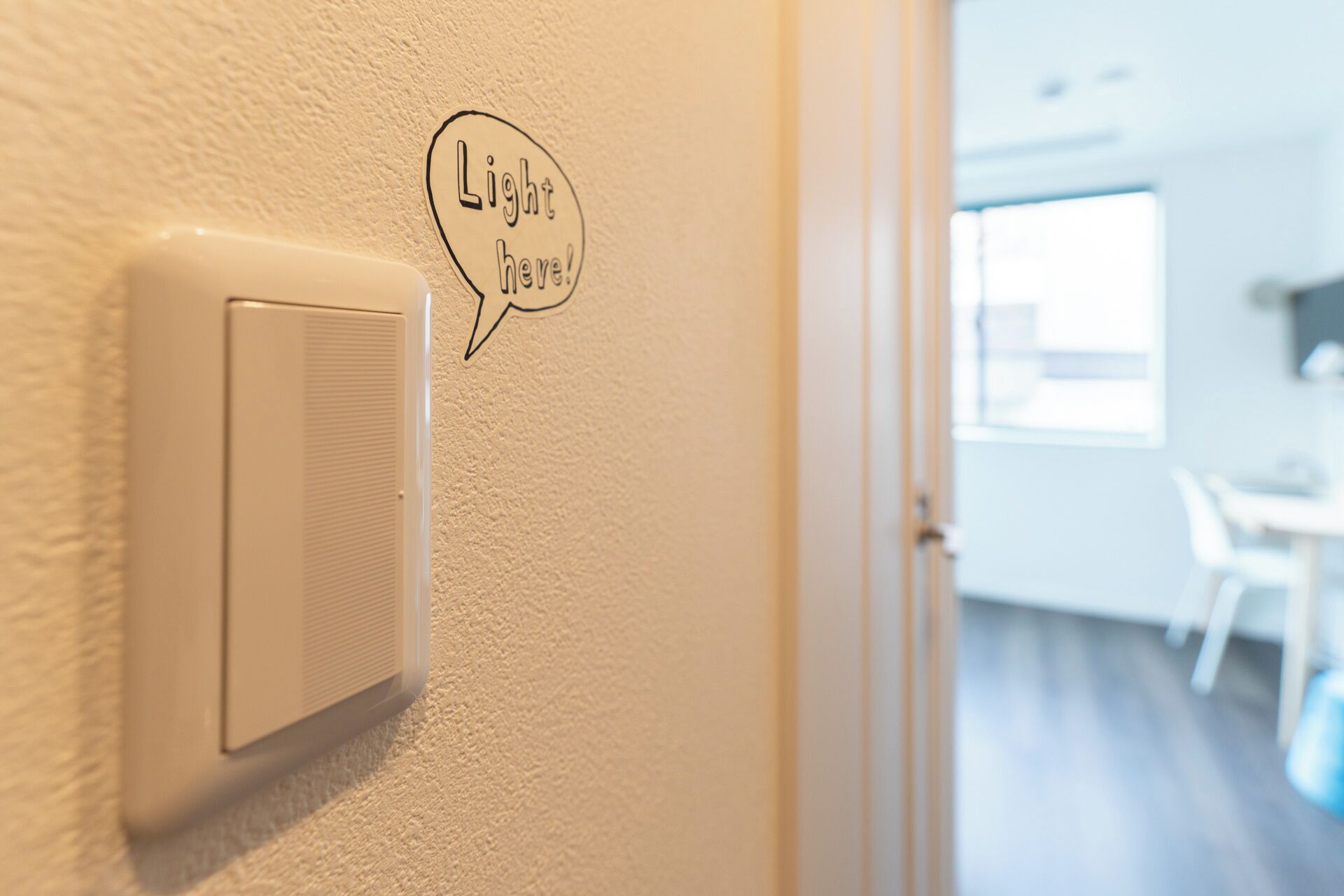 A thermostat on a wall with a speech bubble saying 'Light here!'