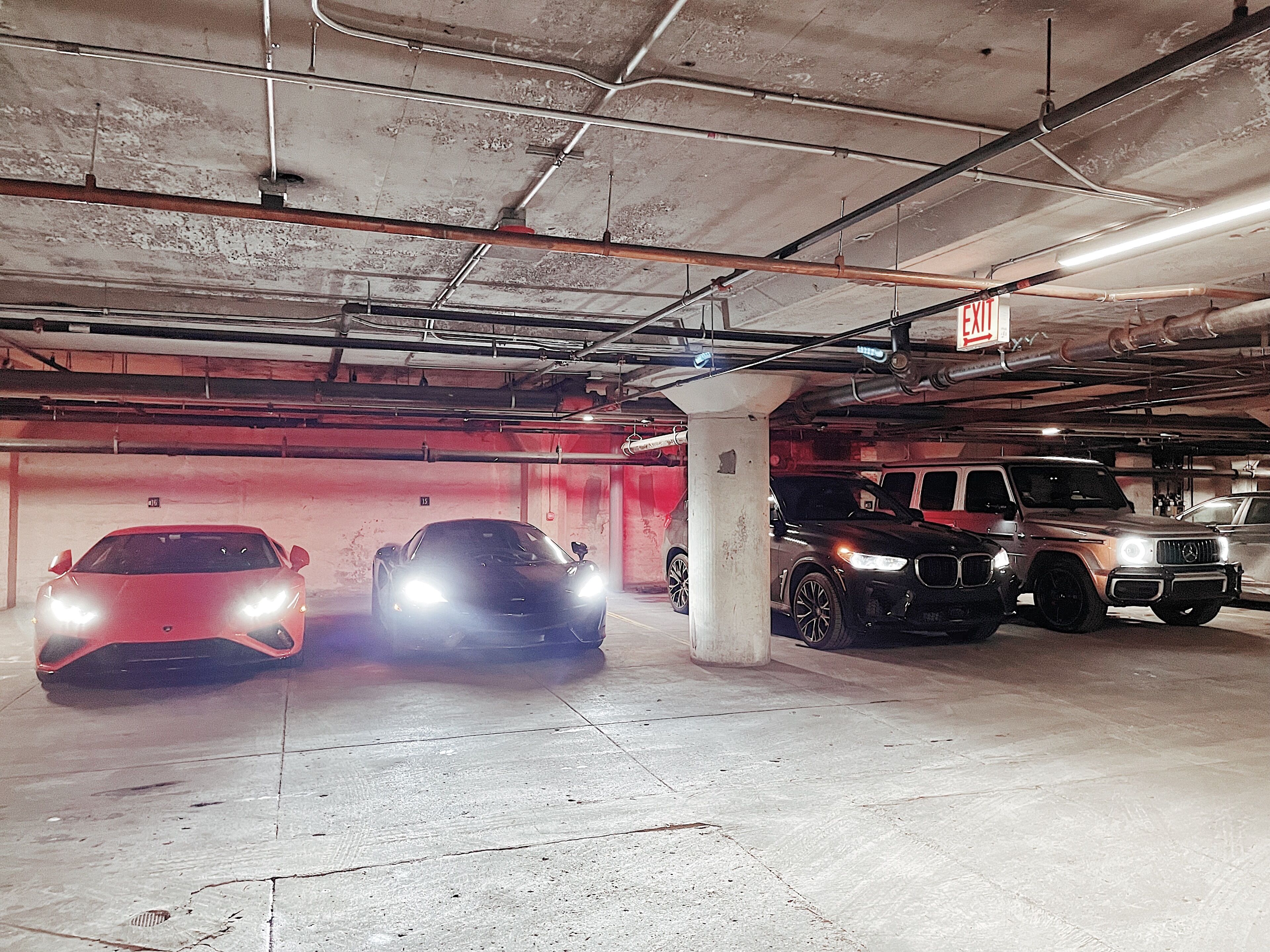 A multi-level parking garage with several cars parked.