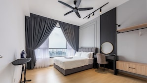 A modern bedroom with a bed, desk, chair, and a ceiling fan. - BeCentral i-City by Manhattan (Shah Alam)