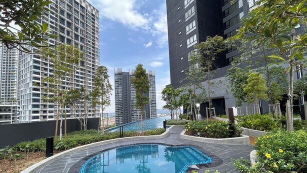 A swimming pool surrounded by greenery and tall buildings. - BeCentral i-City by Manhattan (Shah Alam)