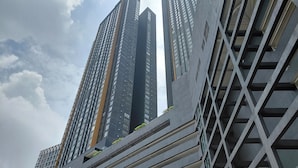 A modern high-rise building with a unique geometric facade and multiple balconies. - BeCentral i-City by Manhattan (Shah Alam)