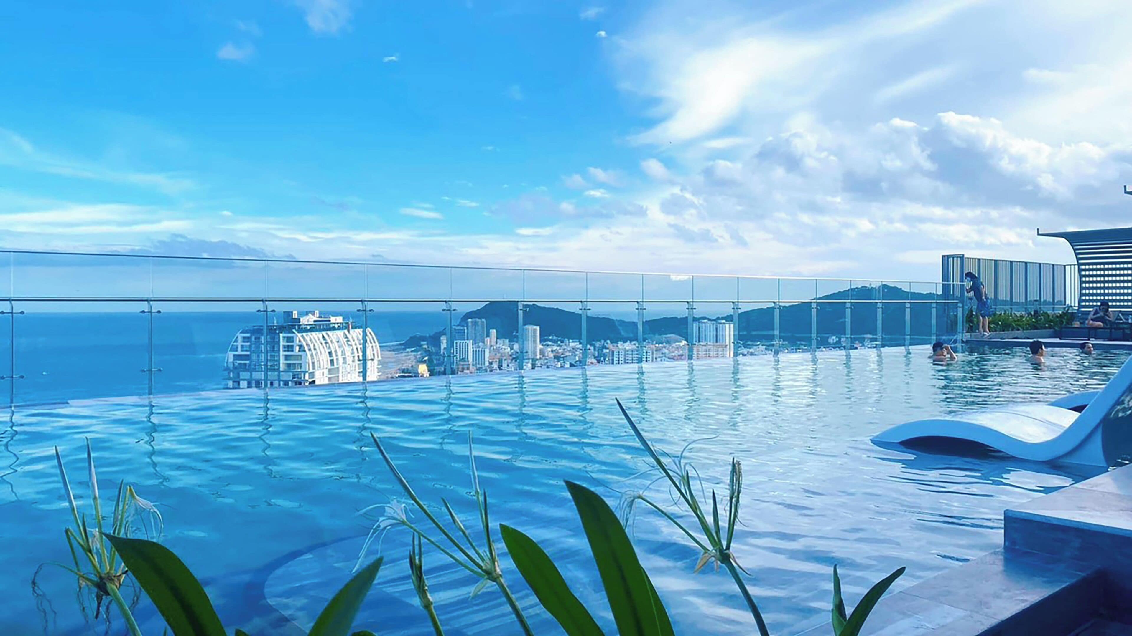 Outdoor pool, pool loungers, lifeguards on site