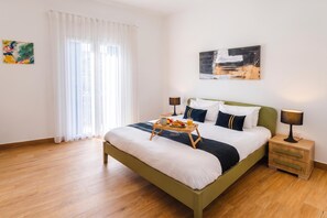 A hotel room with a bed, bedside tables, a window with curtains, and artwork on the walls. - Dar Sara Holiday Gozitan Home, IR-RABAT, Malta (IR-RABAT)