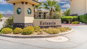A sign for 'Estancia South Pl' with palm trees and a clear sky. - Estancia Resort Unit #404 (Saint George)