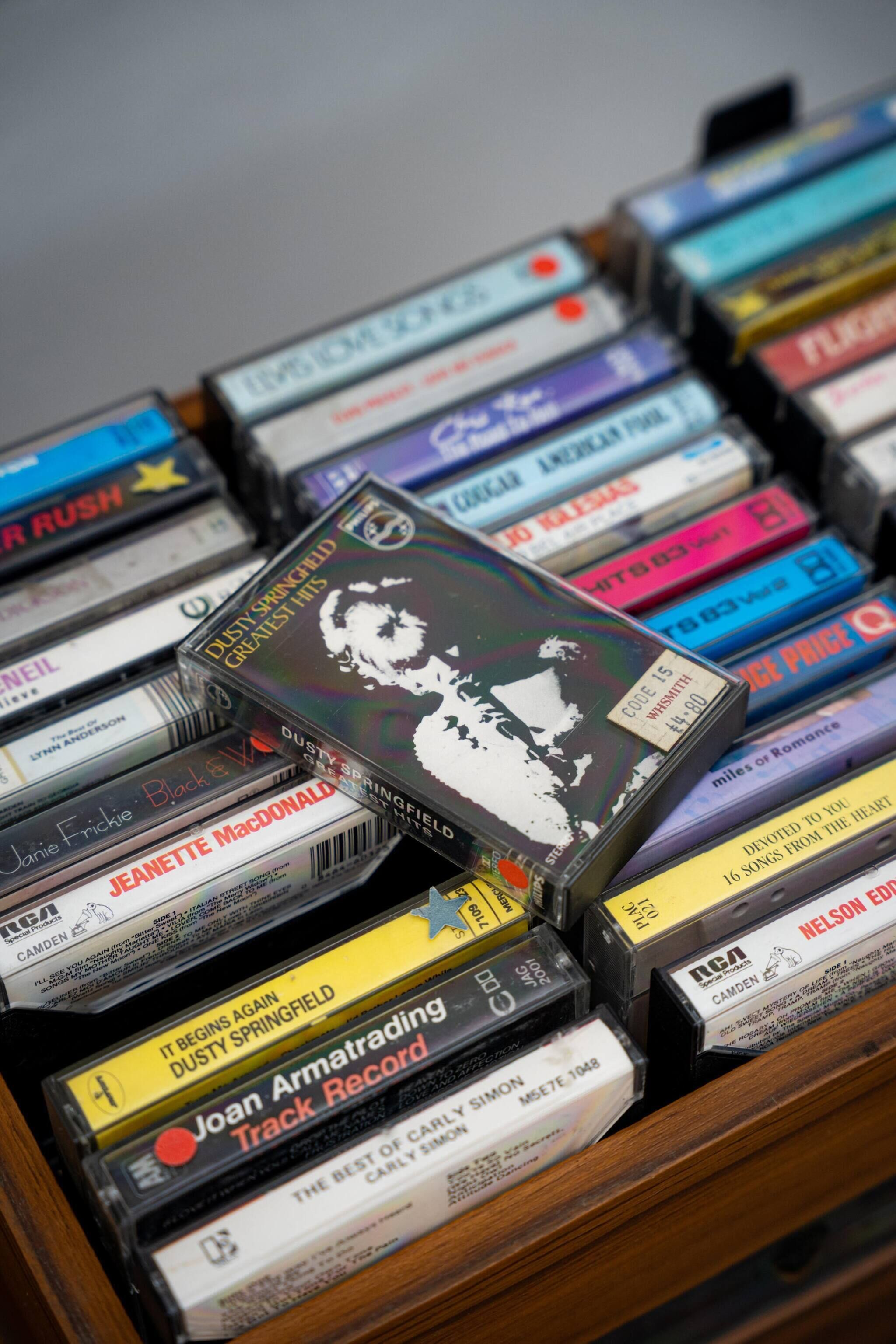 A collection of compact discs with visible album titles and artist names.