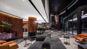 A modern lobby with a reception desk, seating area, and large windows. - IntercityHotel Guangzhou Huadu (Guangzhou)