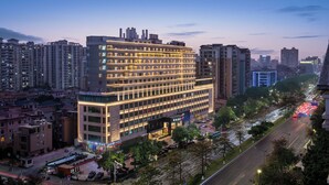A multi-story hotel with a modern design, featuring a prominent entrance and a parking area. - IntercityHotel Guangzhou Huadu (Guangzhou)