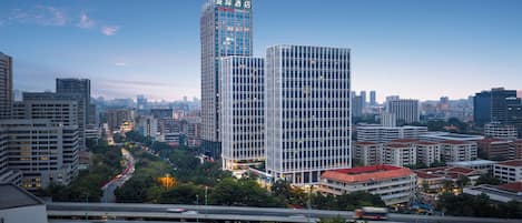 A cityscape with modern high-rise buildings, including a hotel with a prominent sign.