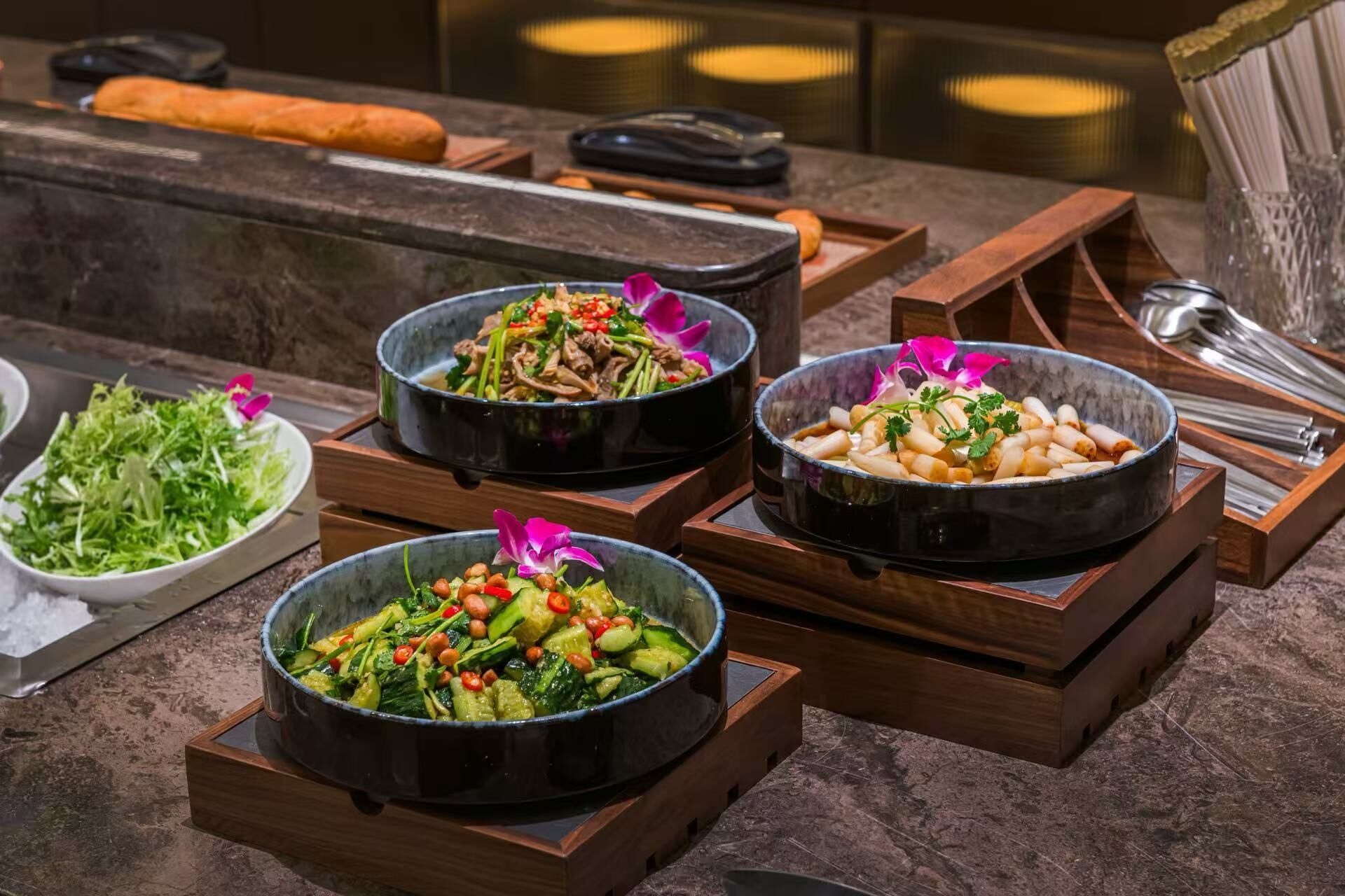 A buffet with various dishes, including salads and stir-fries, arranged on wooden stands.