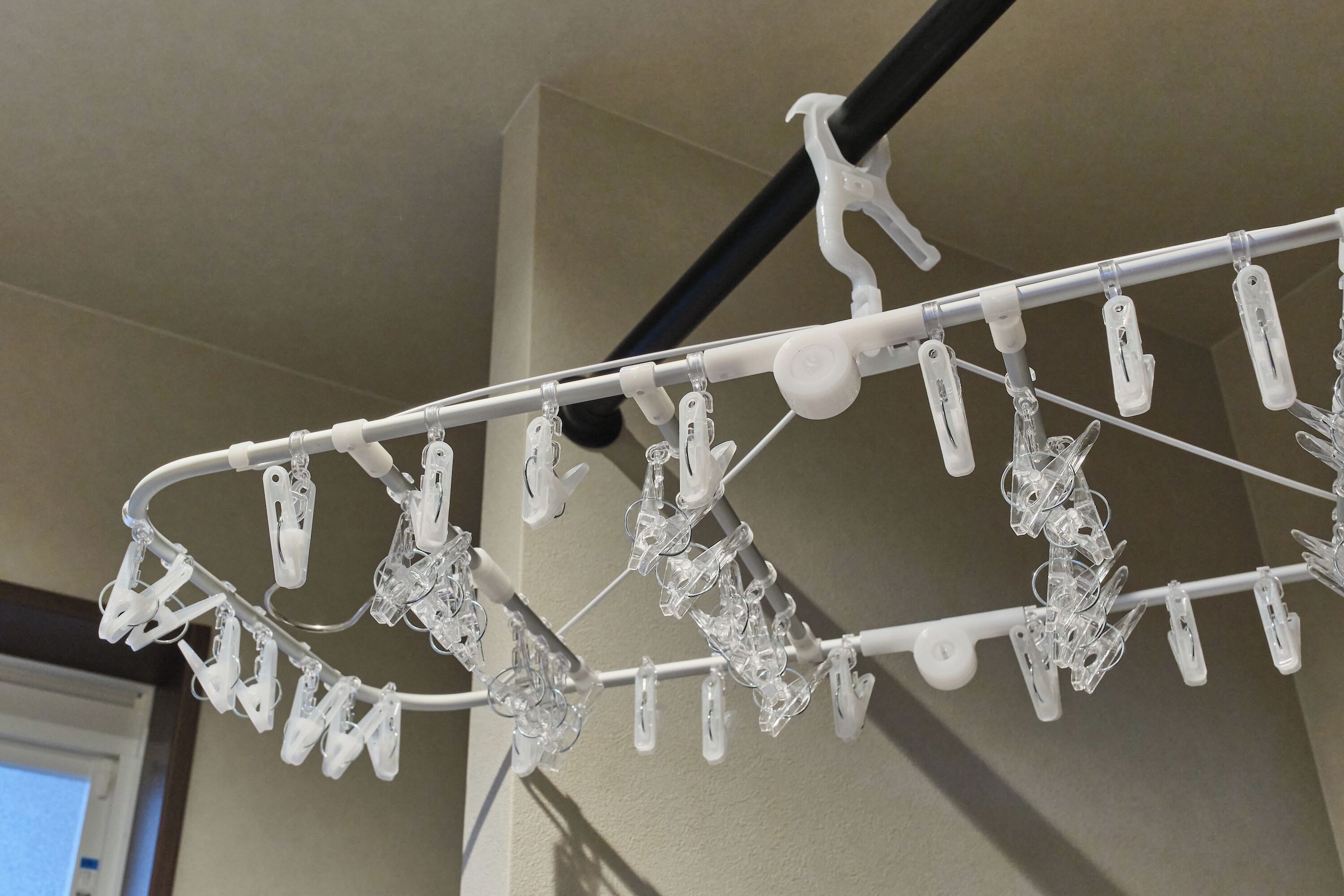 Un étendoir blanc doté de plusieurs pinces en plastique.