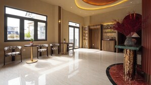 A spacious lobby with a marble floor, large windows, and a reception desk. - NiK Hotel Hillside Da Lat (Xuan Huong - Da Lat)