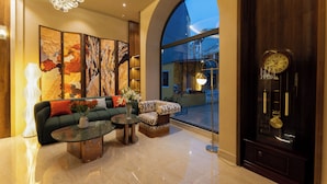 A modern living room with a sofa, coffee table, and decorative items. - NiK Hotel Hillside Da Lat (Xuan Huong - Da Lat)