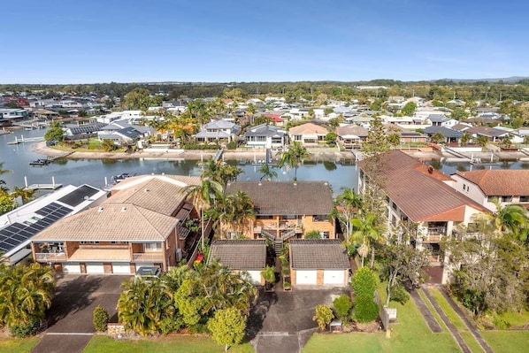 A residential area with houses, a marina, and a clear sky.