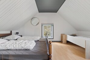 A bedroom with two beds, a skylight, and a small window. - Spacious holiday home near Limfjord and nature (Øster Assels)