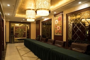 Un salón de conferencias con una larga mesa, sillas e iluminación decorativa.