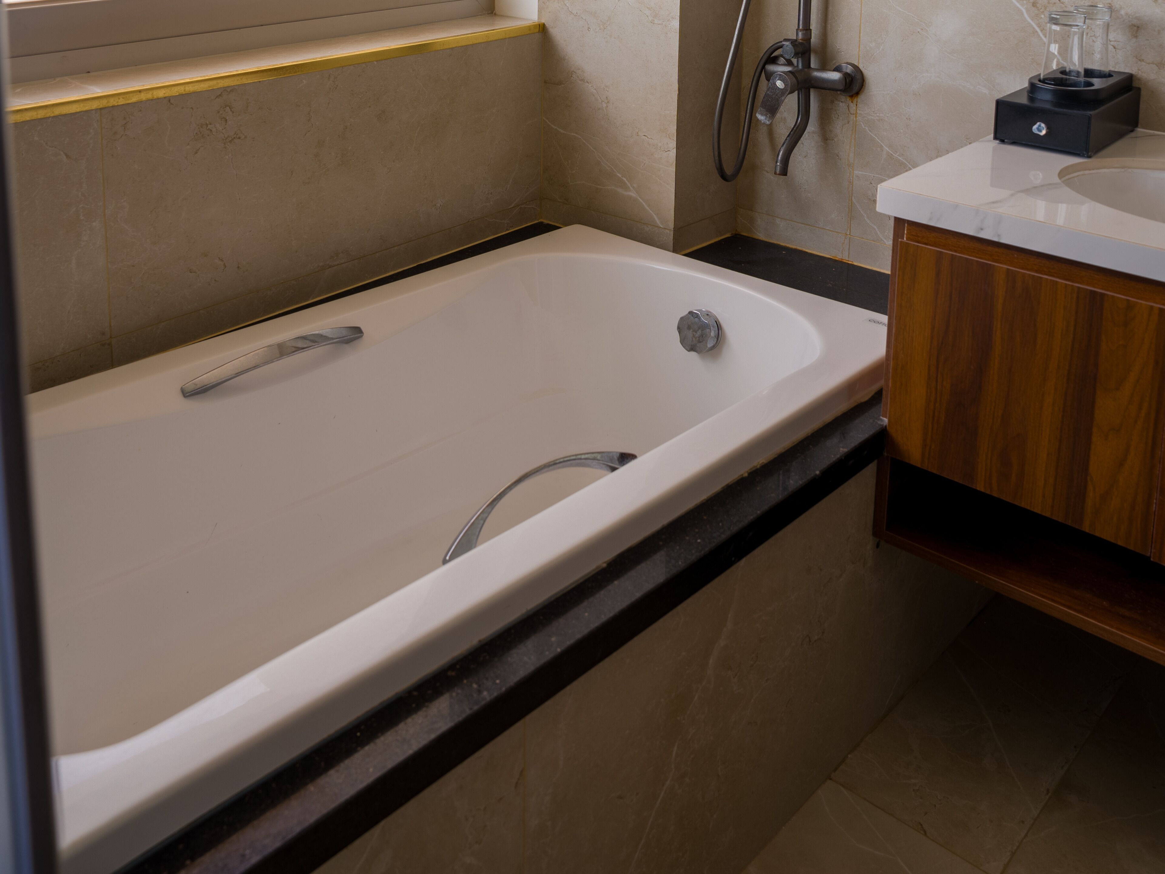 A modern bathroom with a bathtub, a shower, and a sink.