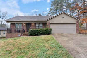 A single-story house with a garage, a front porch, and a well-maintained lawn.