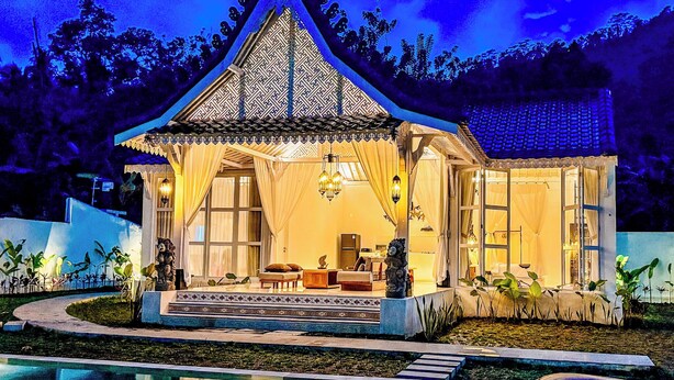 A traditional-style building with a covered porch, a pool, and a view of the surrounding landscape. - Hafrana Villa by AGATA - 700sqm 2BR Villa with Private Pool & Jacuzzi (Selat)