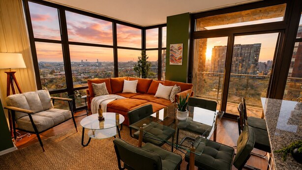 A modern living room with a large window, a sofa, a chair, a coffee table, and a small table. - Skyline 2BR Heart of Chicago Walk to Grant Park (Chicago)