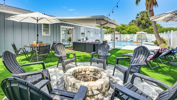 A backyard with a fire pit, outdoor furniture, and a pool. - Outdoor Oasis & All-Ages Fun! Gulf Coast Getaway (Hudson)