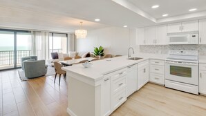 A modern kitchen with white cabinetry, a built-in microwave, and an oven. - Stunning Views, Luxe Decor: Suntide III - Unit 805 (South Padre Island)