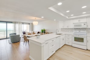 A modern kitchen with white cabinetry, a built-in microwave, and an oven. - Stunning Views, Luxe Decor: Suntide III - Unit 805 (South Padre Island)