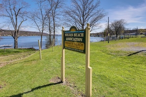 A sign for Silvan Beach Association Private Beach, with a grassy area and trees in the background. - Dog-Friendly Home w/ Dock & Views on Waneta Lake! (Wayne)