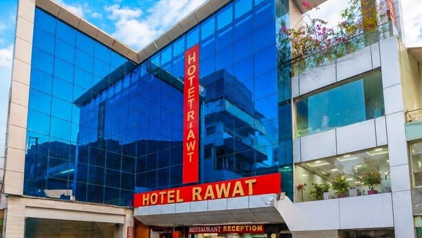 A modern hotel with a glass facade, a prominent red sign, and a restaurant reception area. - Hotel Rawat Near Railway Station, Jaipur (Jaipur)