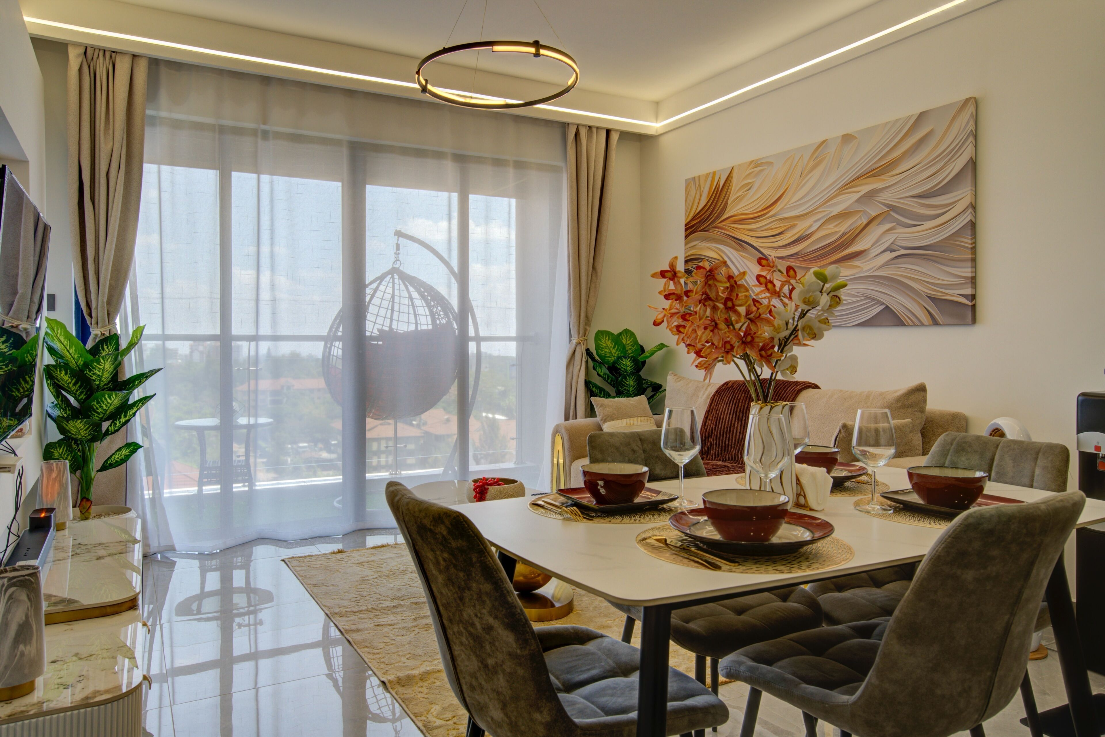 A modern dining area with a large table, chairs, and a view of the outdoors.