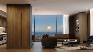 A modern living room with a city view, a sofa, a coffee table, and a dining area. - Radisson Blu Residence Istanbul Kartal (Istanbul)