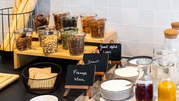 A breakfast buffet with various food items and condiments.