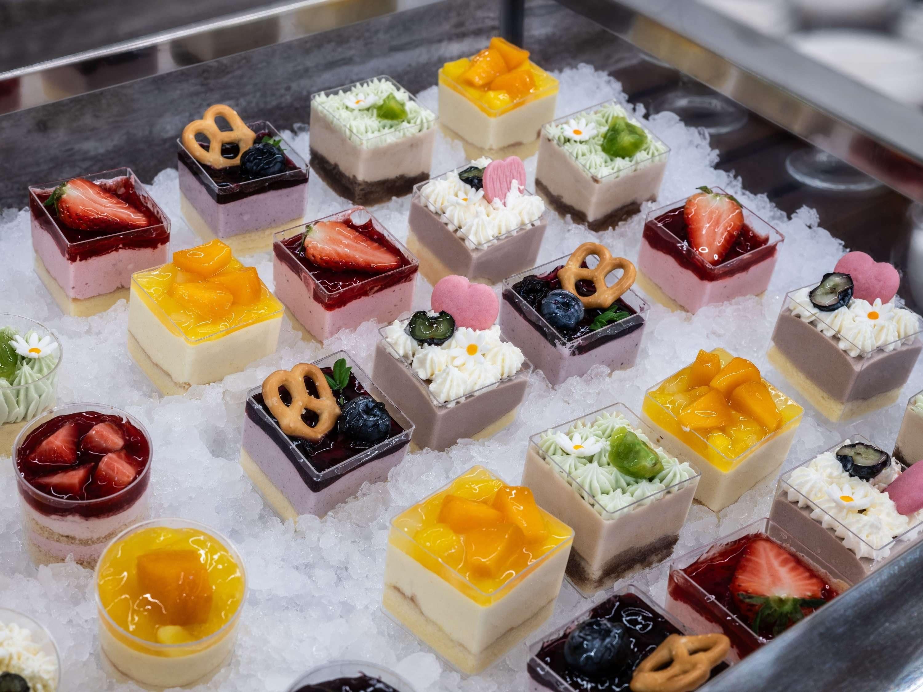 A variety of desserts arranged on a bed of ice.